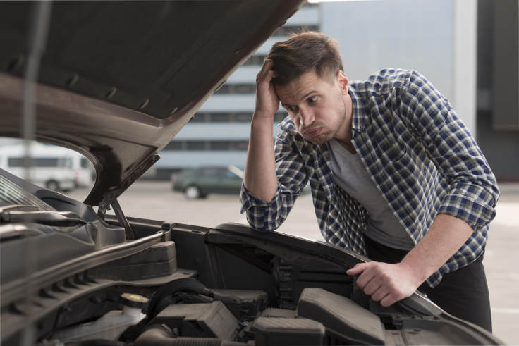 Young Man Trying to Repair Car